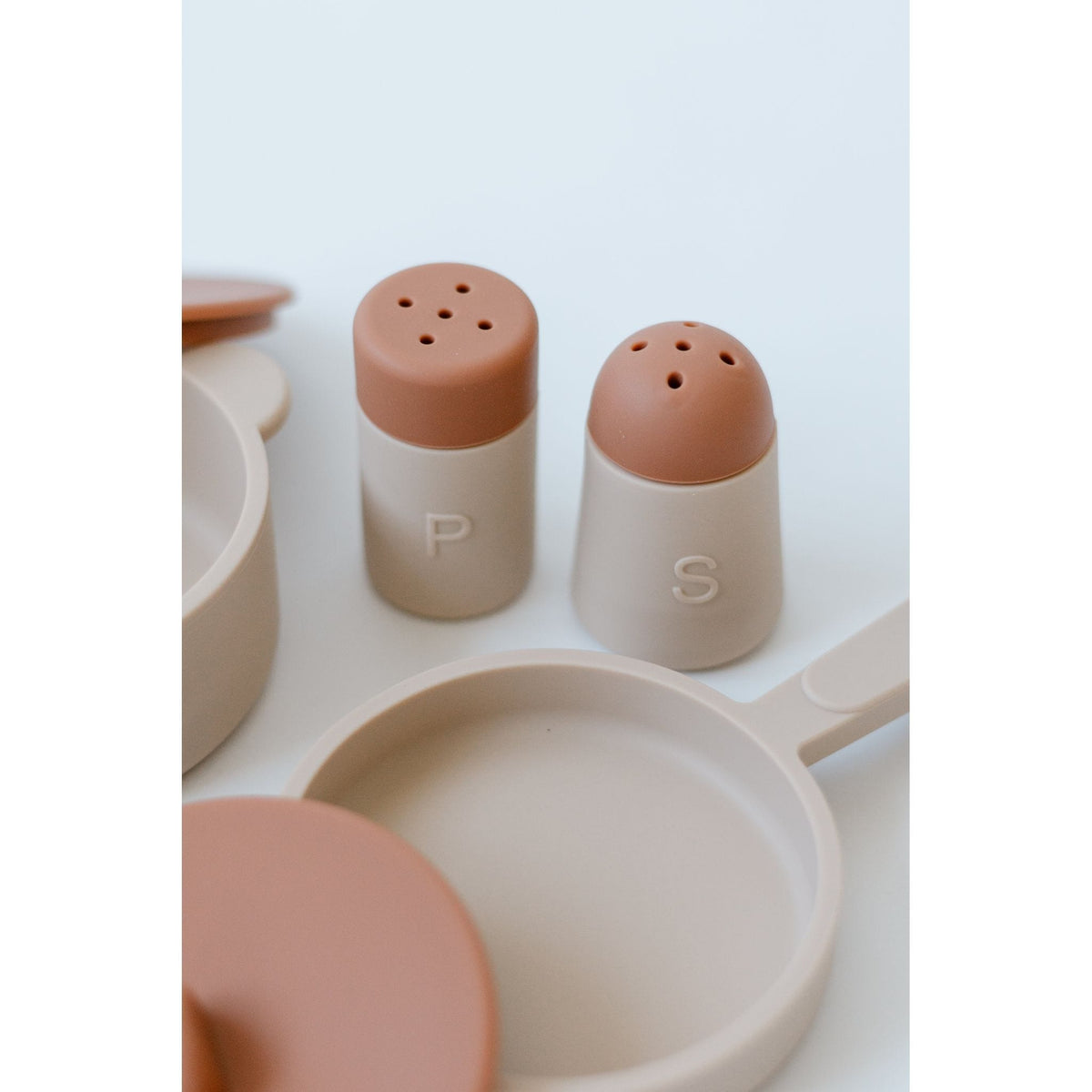 Colorful silicone toy cooking set with pots, pans, and utensils for kids, designed for imaginative play and easy cleaning.
