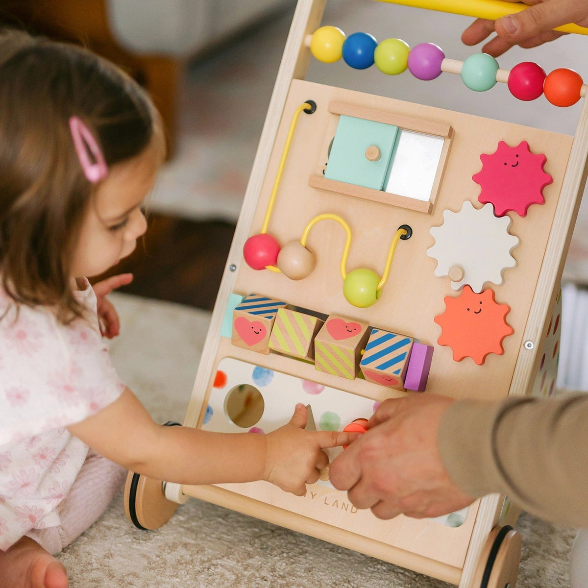Natural wooden baby walker by Tiny Land INC with colorful activity panels and sturdy design for early walkers.