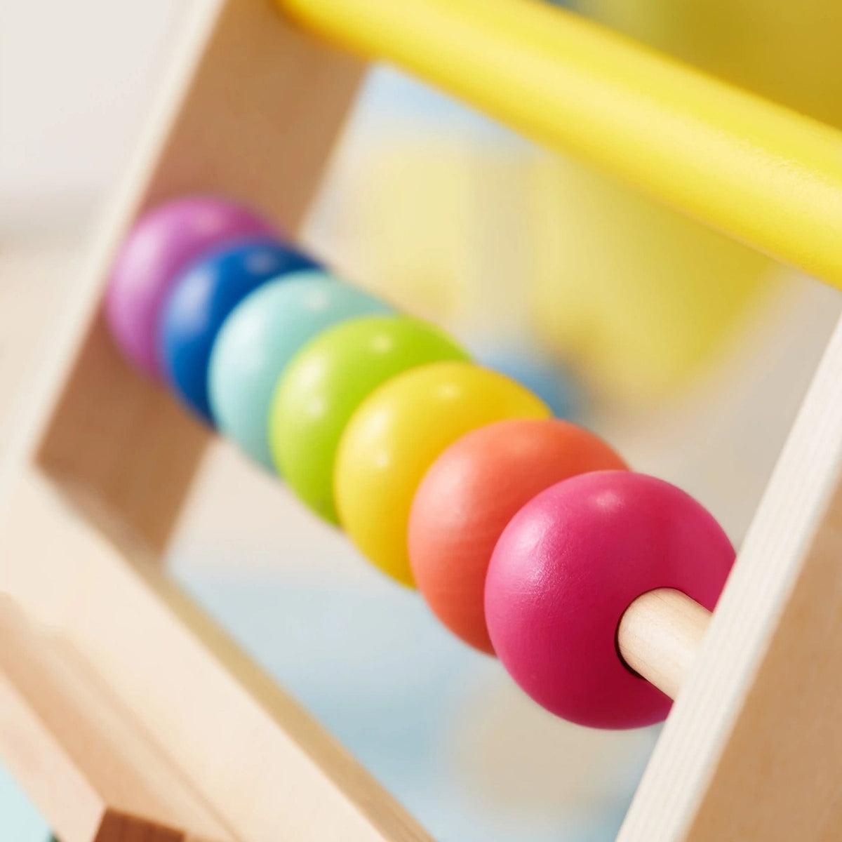 Natural wooden baby walker by Tiny Land INC featuring smooth finish and sturdy legs, designed for toddler mobility and play.