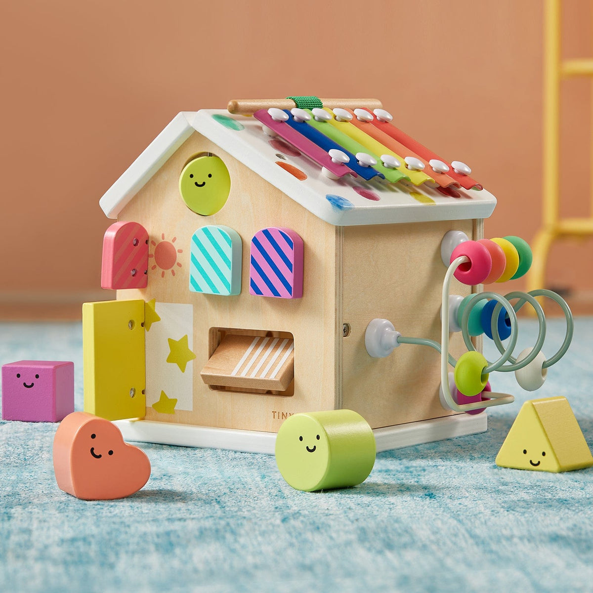 Colorful Tiny Land® Cottage Activity Cube with rainbow design, featuring engaging shapes and activities for children.