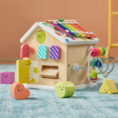 Children's wooden toy with colorful shapes and a bead roller on a blue surface.