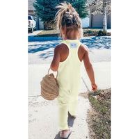 Be Mi Los Angeles butter yellow romper displayed on a model, showcasing its stylish sleeveless design and relaxed fit.