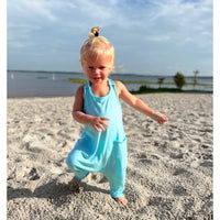 Be Mi Los Angeles aqua romper displayed on a model, featuring a stylish and comfortable one-piece design perfect for warm weather.