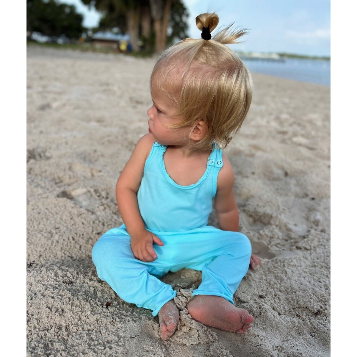 Be Mi Los Angeles aqua romper shown on a model, featuring a stylish, lightweight design perfect for warm weather.