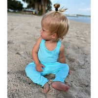 Be Mi Los Angeles aqua romper shown on a model, featuring a stylish, lightweight design perfect for warm weather.