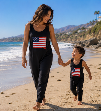 Woman and child walking on a beach with American flag shirts