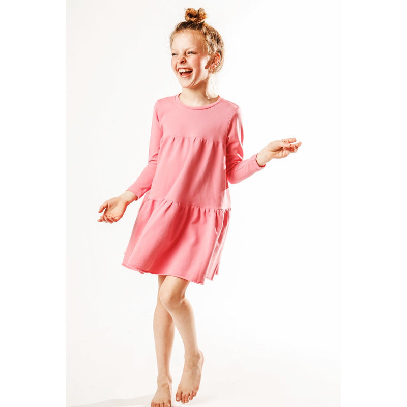 little girl wearing organic pink swing dress