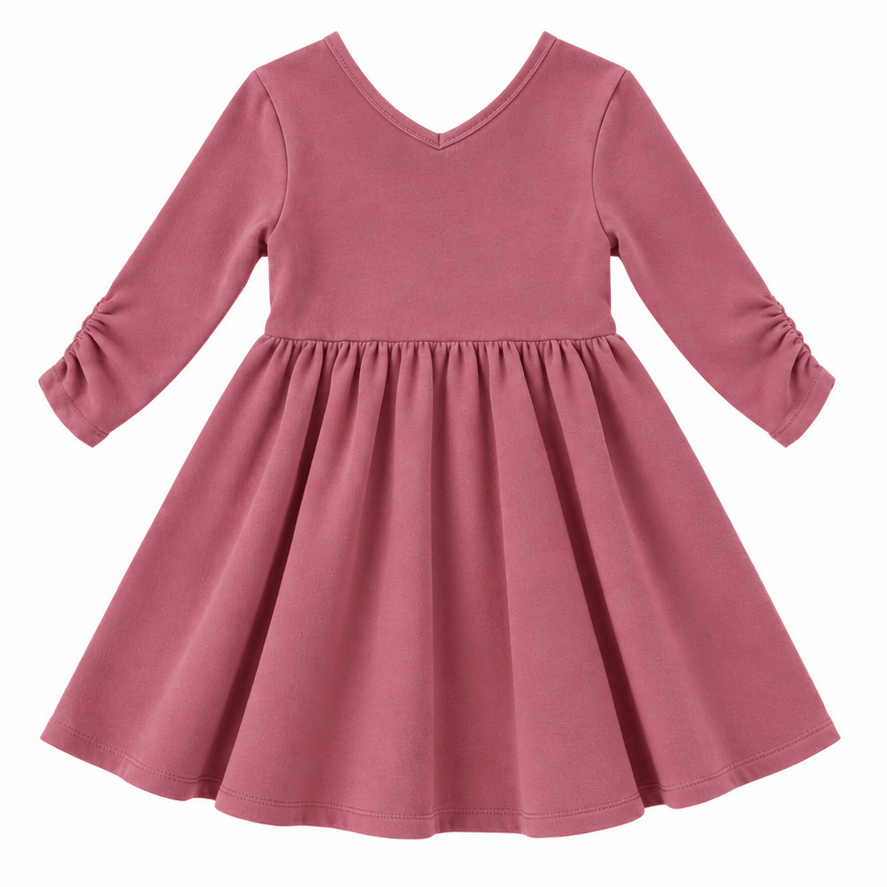 the Nova organic cotton twirl dress in muted berry, featuring a full circle skirt, round neckline, and delicate ruched sleeves.