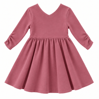 the Nova organic cotton twirl dress in muted berry, featuring a full circle skirt, round neckline, and delicate ruched sleeves.