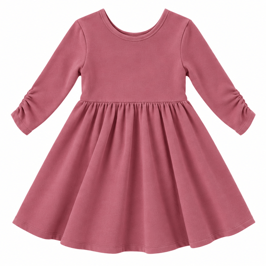 the Nova organic cotton twirl dress in muted berry, featuring a full circle skirt, round neckline, and delicate ruched sleeves.
