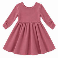 the Nova organic cotton twirl dress in muted berry, featuring a full circle skirt, round neckline, and delicate ruched sleeves.