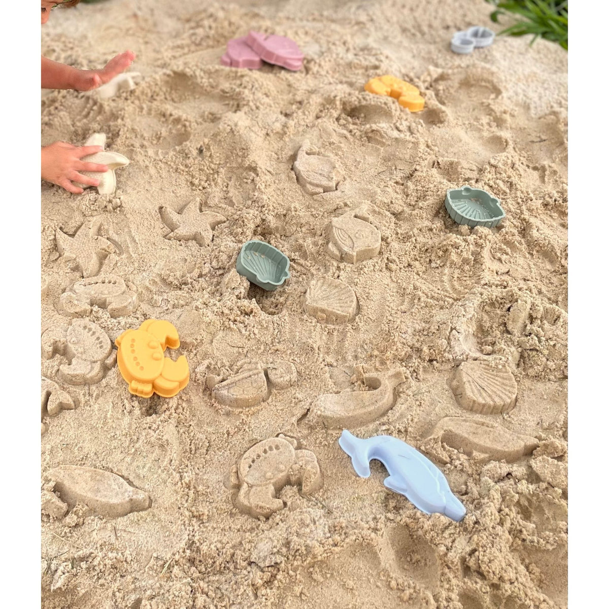 Silicone sand bucket with colorful toys and shovel for kids, ideal for outdoor play and building sandcastles.
