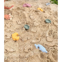 Silicone sand bucket with colorful toys and shovel for kids, ideal for outdoor play and building sandcastles.