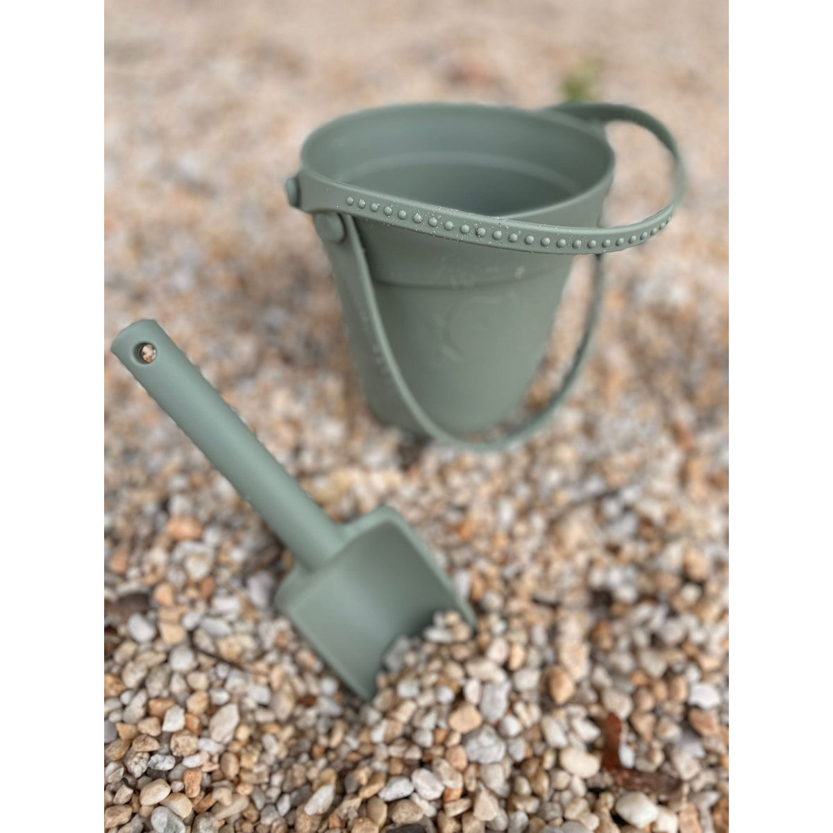 ShopMyLittleSongbird silicone sand toy bucket with colorful toys and shovel for kids' beach play and sandcastle building.