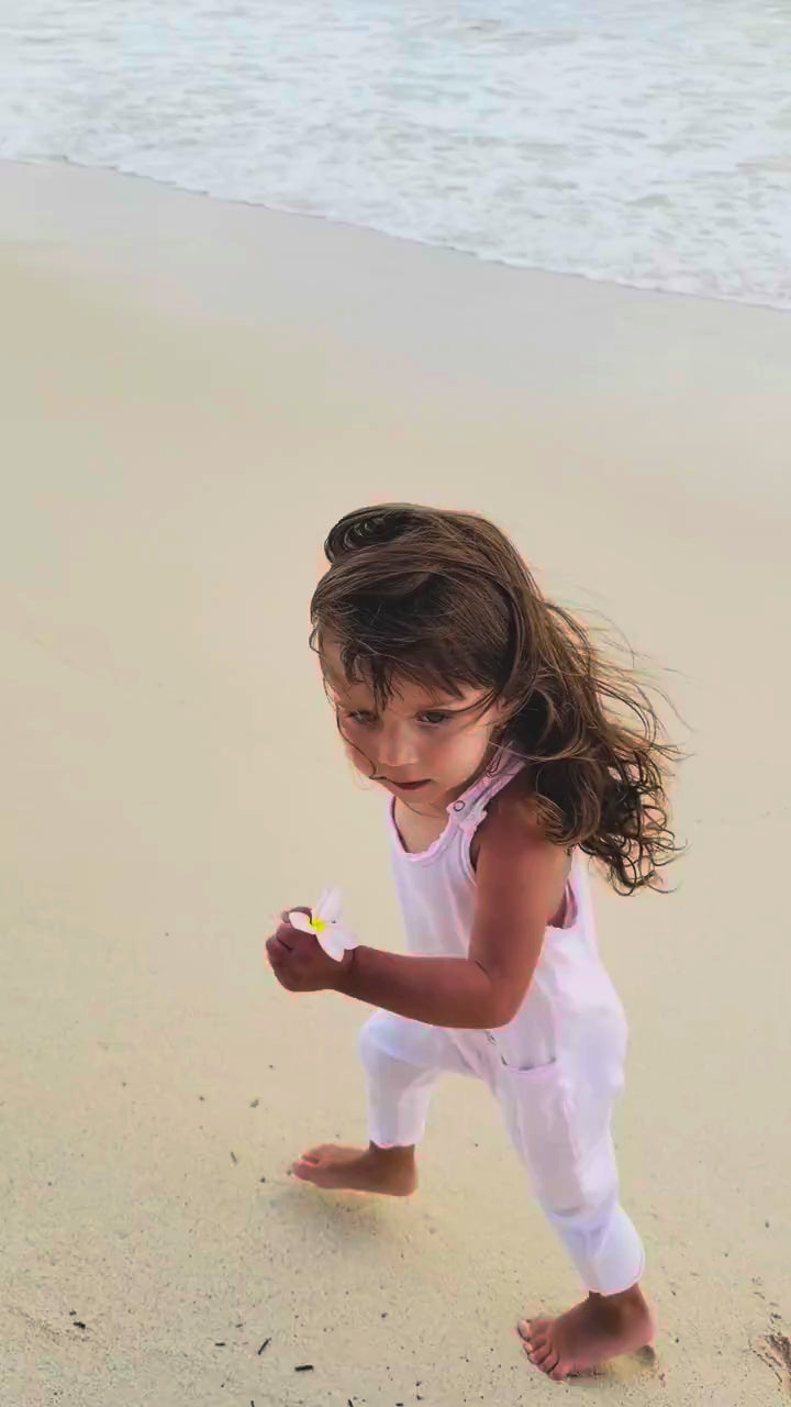 Video with text - compressed - girl running in white romper on beach
