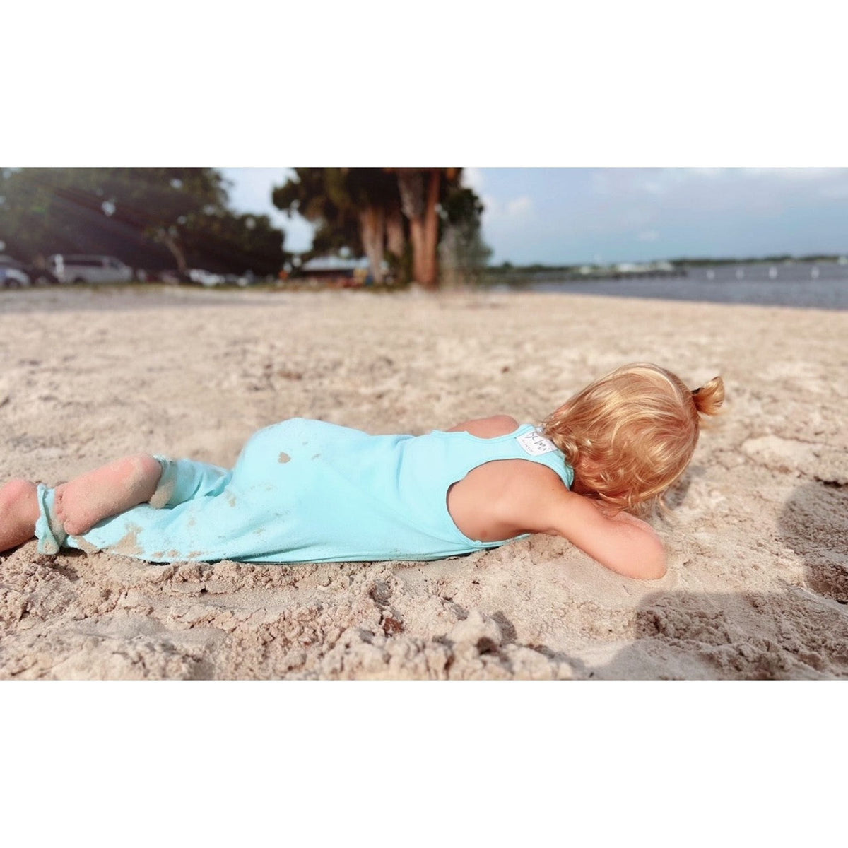 Be Mi Los Angeles aqua romper displayed on a model, featuring a stylish, lightweight design perfect for warm weather.
