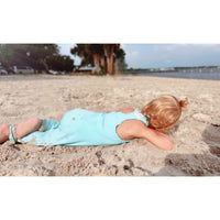 Be Mi Los Angeles aqua romper displayed on a model, featuring a stylish, lightweight design perfect for warm weather.