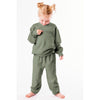 Child wearing a green outfit on a white background