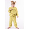 Child wearing a yellow outfit with text on a white background