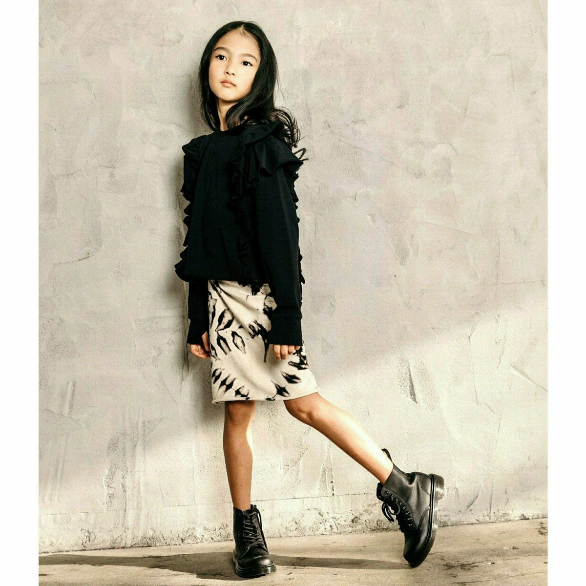 Black organic Victoria ruffle sleeve top by Be Mi Los Angeles, showing the stylish ruffled sleeves and lightweight fabric.