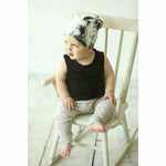 baby boy wearing organic tie dye beanie and organic pants, black cotton baby tank