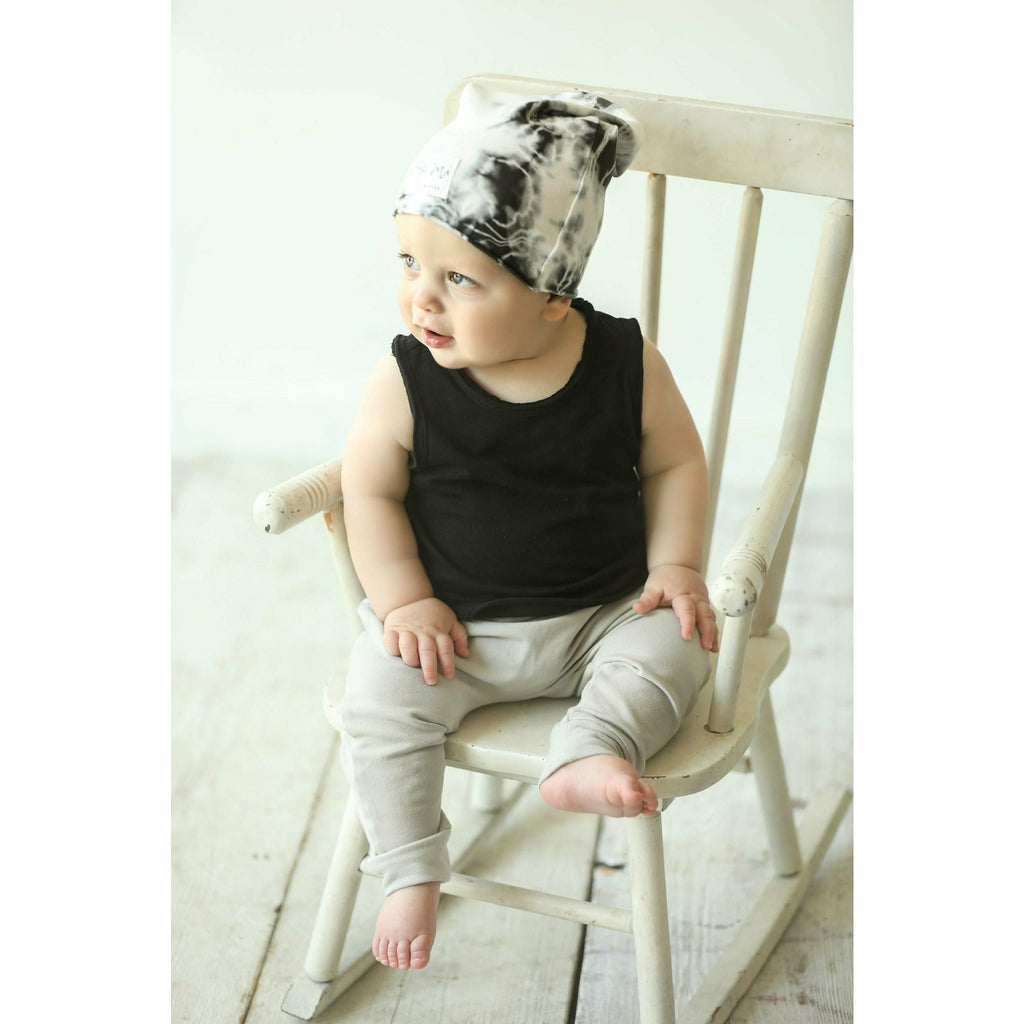 baby wearing organic beanie and pants soft cotton tank black and beige