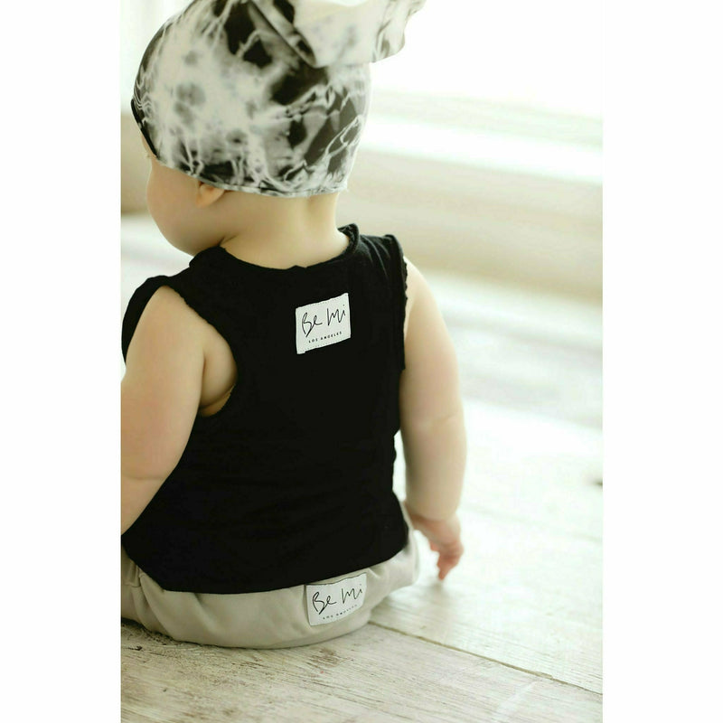 baby wearing black cotton soft tank and organic beanie and pants