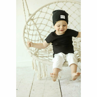 boy wearing cotton soft tee organic beanie and white shorts