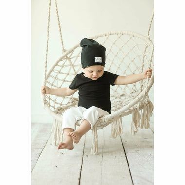 baby wearing organic beanie and pants soft cotton tank black and beige