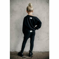 Black organic Malibu joggers by Be Mi Los Angeles with distressed details, casual fit, and comfortable fabric.