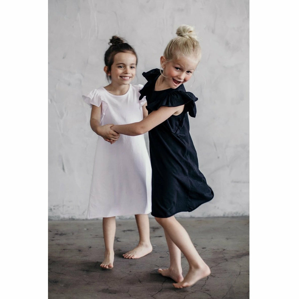 Black Valentina Ruffle Dress by Be Mi Los Angeles featuring ruffled details and a fitted silhouette.