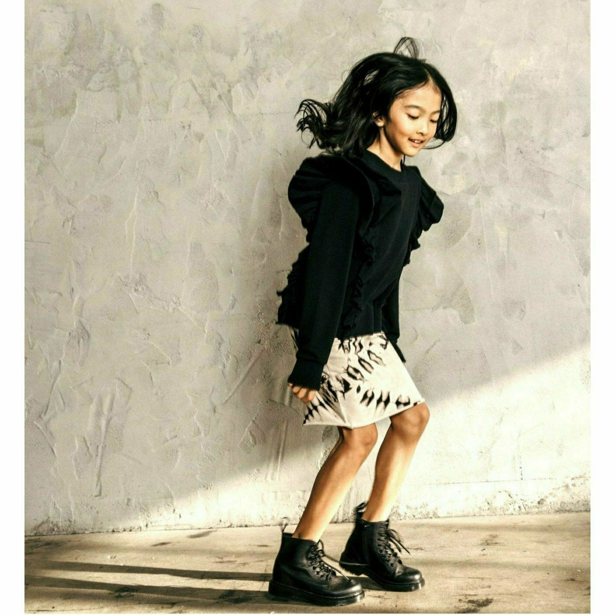 Black organic Victoria ruffle sleeve top by Be Mi Los Angeles, featuring feminine ruffle details and a stylish, comfortable fit.