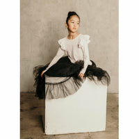 Black ballerina skirt by Be Mi Los Angeles, flowing fabric with soft pleats, displayed on a neutral background.
