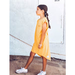 An adorable honey-colored tee dress for girls, made from buttery soft and comfy 100% Combed Cotton. The dress features a modern design that can be easily layered with a jacket or belt for a more polished look. Perfect for any occasion, this dress is designed to make your little one feel confident and stylish.