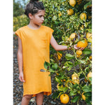 An adorable honey-colored tee dress for girls, made from buttery soft and comfy 100% Combed Cotton. The dress features a modern design that can be easily layered with a jacket or belt for a more polished look. Perfect for any occasion, this dress is designed to make your little one feel confident and stylish.