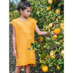 An adorable honey-colored tee dress for girls, made from buttery soft and comfy 100% Combed Cotton. The dress features a modern design that can be easily layered with a jacket or belt for a more polished look. Perfect for any occasion, this dress is designed to make your little one feel confident and stylish.