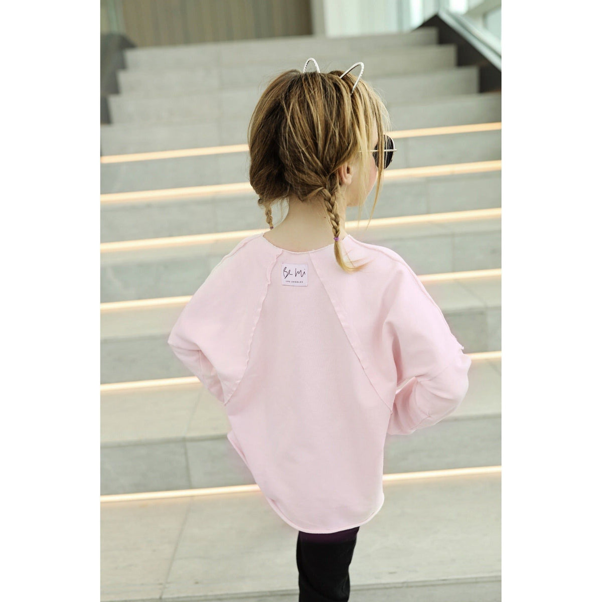 Be Mi Los Angeles organic V raw edge sweatshirt, showcasing its relaxed fit and raw hem design on a neutral background.