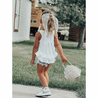 little girl wearing white cotton soft ruffle tank