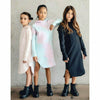 three girls wearing organic hoodie dresses in pink black and tie dye