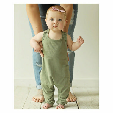 Olive-colored baby romper by Be Mi Los Angeles, soft cotton fabric, cute and comfortable for infants.