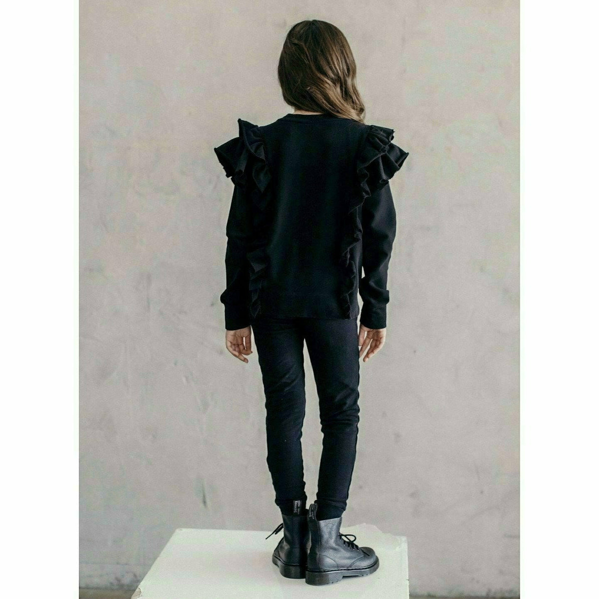 Black organic Victoria ruffle sleeve top by Be Mi Los Angeles, featuring stylish ruffled sleeves and a relaxed fit.