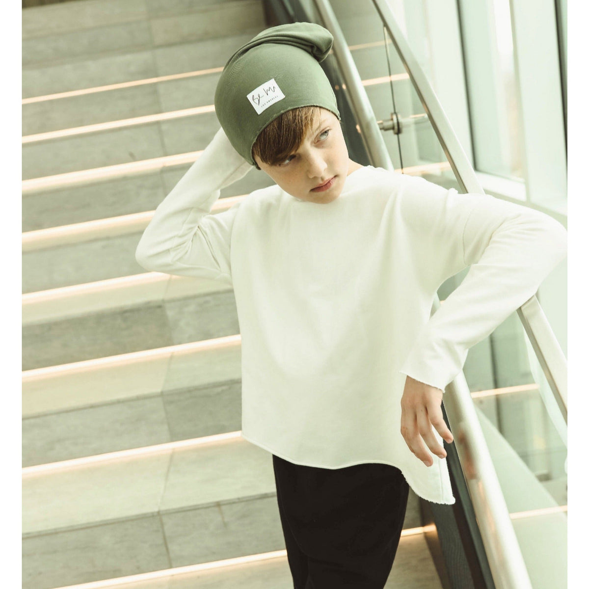 Organic oversized beanie by Be Mi Los Angeles, soft knit fabric, worn slouchy style, in neutral color, close-up of textured material.