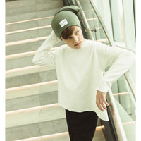 Organic oversized beanie by Be Mi Los Angeles, soft knit fabric, worn slouchy style, in neutral color, close-up of textured material.