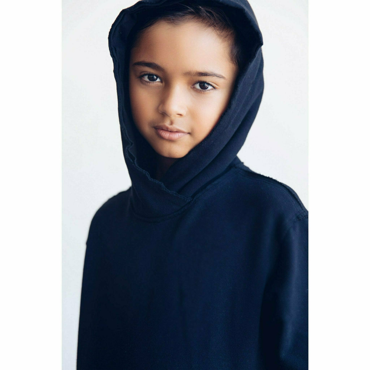 Black organic cotton Benji kids' hoodie from Be Mi Los Angeles, featuring a cozy sweatshirt design for children.
