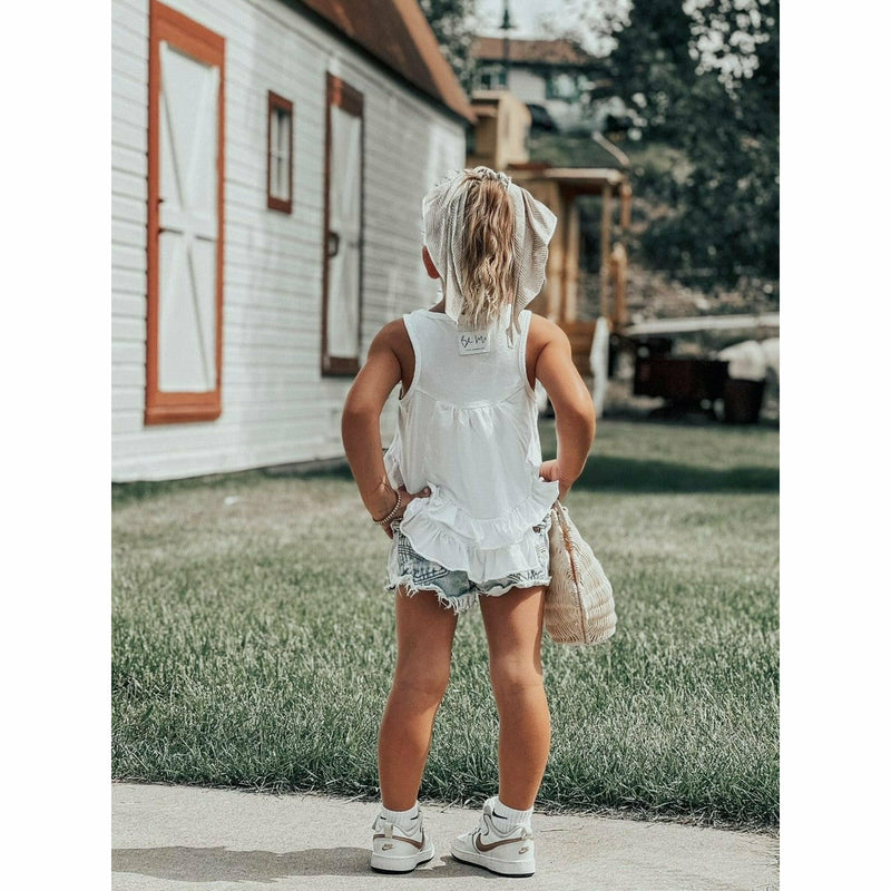 little girl wearing white cotton soft ruffle tank