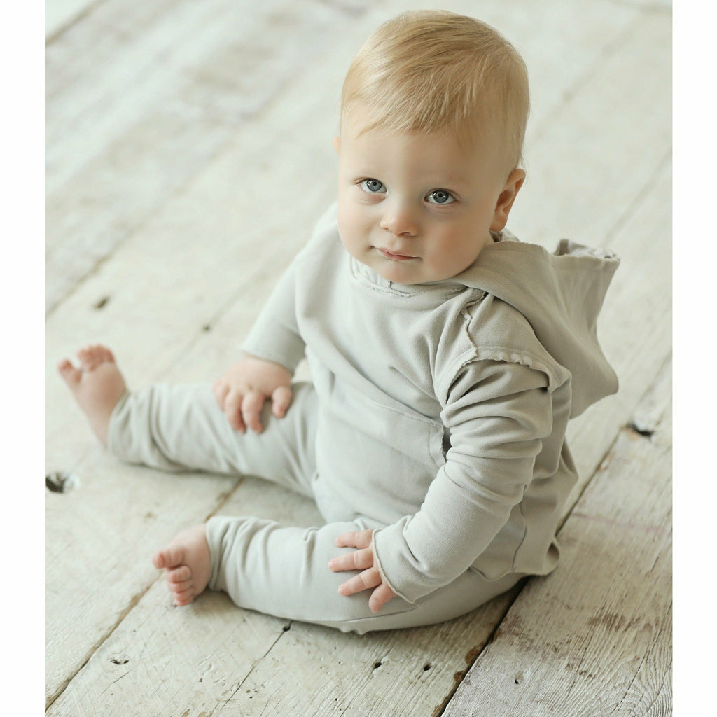 baby wearing organic beanie and pants soft cotton tank black and beige