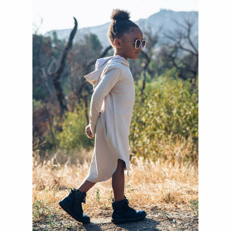 girl wearing organic hoodie dress and dr martens shoes