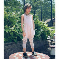Be Mi Los Angeles tan romper laid flat, showing its stylish sleeveless design and relaxed fit for casual summer wear.